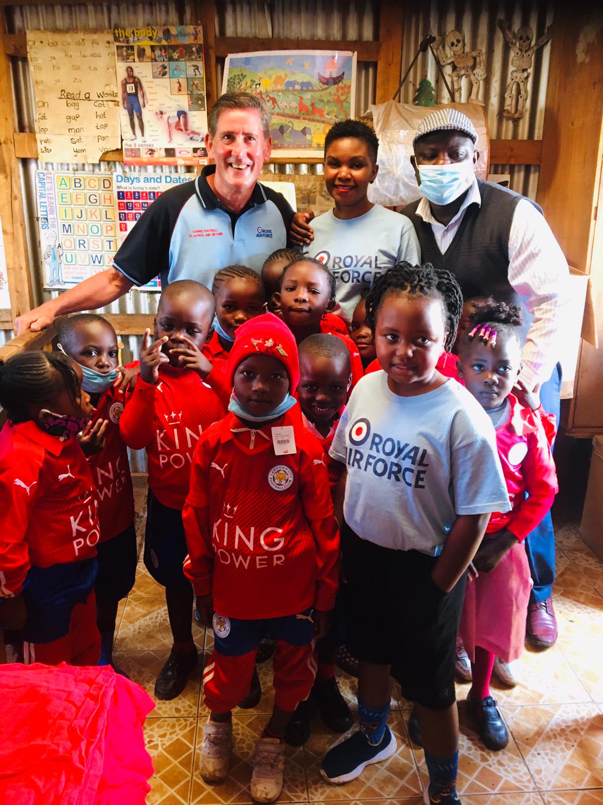 Personnel from the Taking Football to Africa and Beyond Appeal with children and young people wearing football kit donated through the appeal.